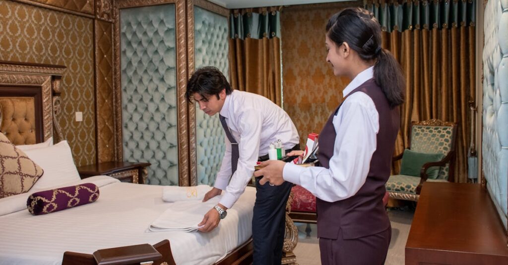 Hotel staff arranging bedding in a luxury room, showcasing service quality in Islamabad.