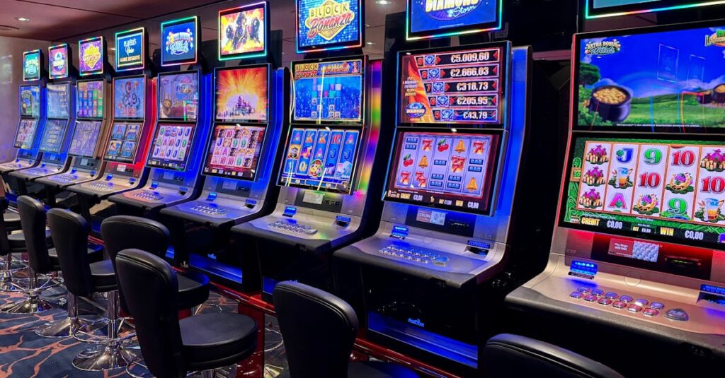 Bright casino slot machines with colorful displays and no people present.