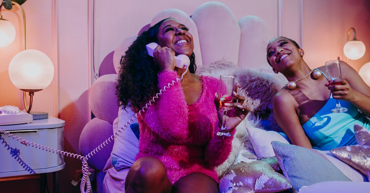 Women enjoying a cozy night with neon lights, laughter, and relaxation.